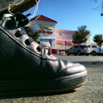 Close up of black Mozo Chef Shoes outside with In-n-Out burger in the background